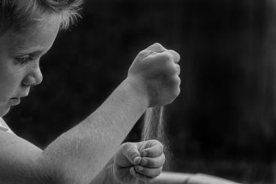 Foto: en liten gutt som leker med sand